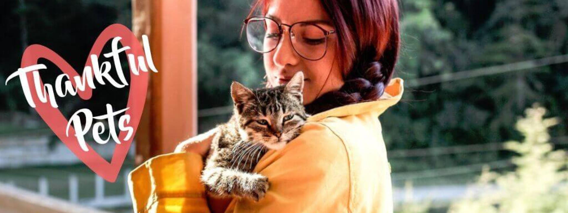 A woman hugging her cat